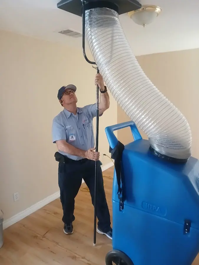 Furnace Tune-Up technician using HEPA equipment in Lakeland Village
